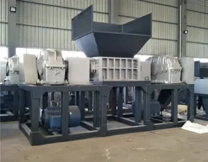Heavy-duty twin shaft shredder machine in stock for industrial waste recycling.