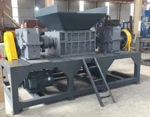 Industrial-grade double shaft shredder equipped with a maintenance platform and ladder.