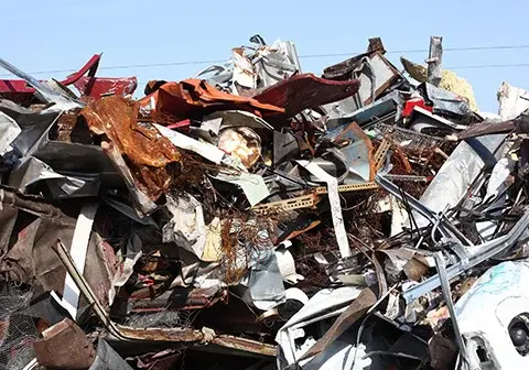 industrial shredder handling scrap metal pile waste