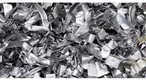 Uniformly shredded scrap metal strips produced by a twin shaft shredder for efficient recycling and transportation.