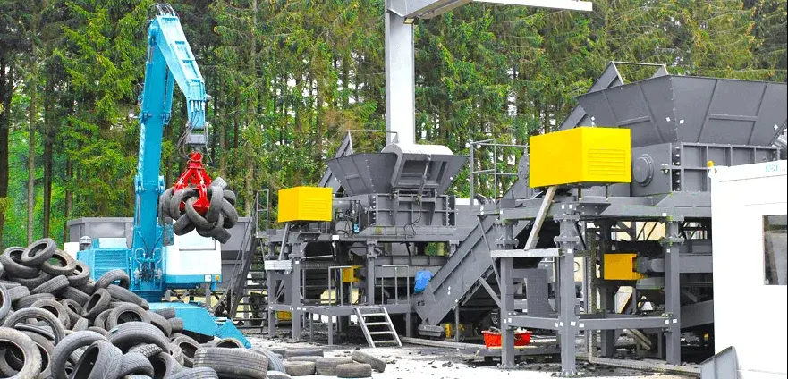 waste tire processing site with industrial shredding machine
