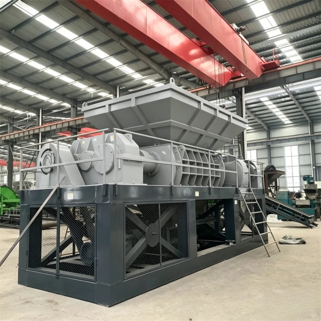 Large double shaft shredder for industrial plastic recycling in manufacturing facility